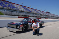 Former NASCAR driver Dale Earnhardt Jr. poses for a picture with the restored 1984 Chevy Nova driven by his father, the late Dale Earnhardt Sr. - Source: Imagn