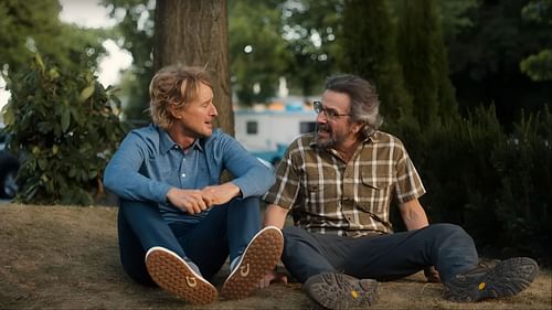Owen Wilson as Pryce Cahill and Marc Maron as Mitts – Pryce reconnects with his former caddy as they support a new rising star on the golf course. (Image via YouTube/AppleTV)