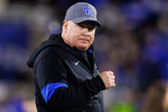 SEC coach Mark Stoops runs onto the field - Source: Imagn