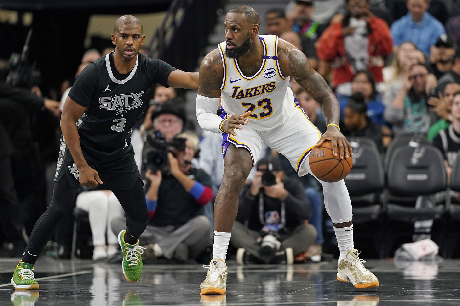 Nov 15, 2024; San Antonio, Texas, USA; Los Angeles Lakers forward LeBron James (23) looks to pass the ball while defended by San Antonio Spurs guard Chris Paul (3) during the first half during the first half at Frost Bank Center. Mandatory Credit: Scott Wachter-Imagn Images - Source: Imagn