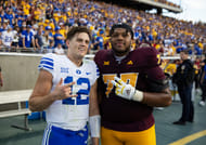 Jake Retzlaff (12) takes a photo with Arizona State Sun Devils offensive lineman Kyle Scott (77) - Source: Imagn