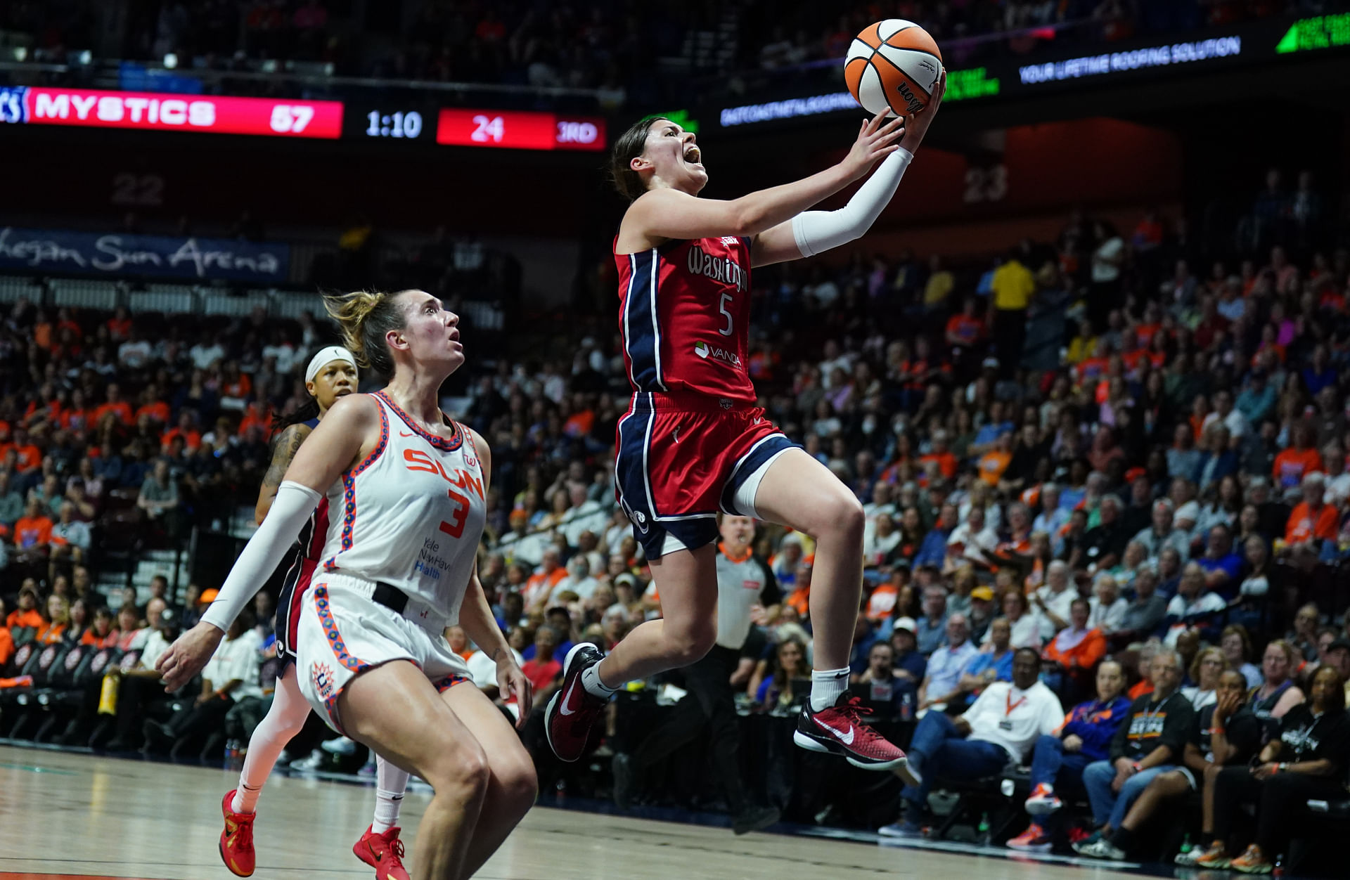 May 18, 2025; Uncasville, Connecticut, USA; Washington Mystics guard Jade Melbourne (5) drives to the basket against Connecticut Sun guard Marina Mabrey (3) in the second half at Mohegan Sun Arena. Mandatory Credit: David Butler II-Imagn Images - Source: Imagn