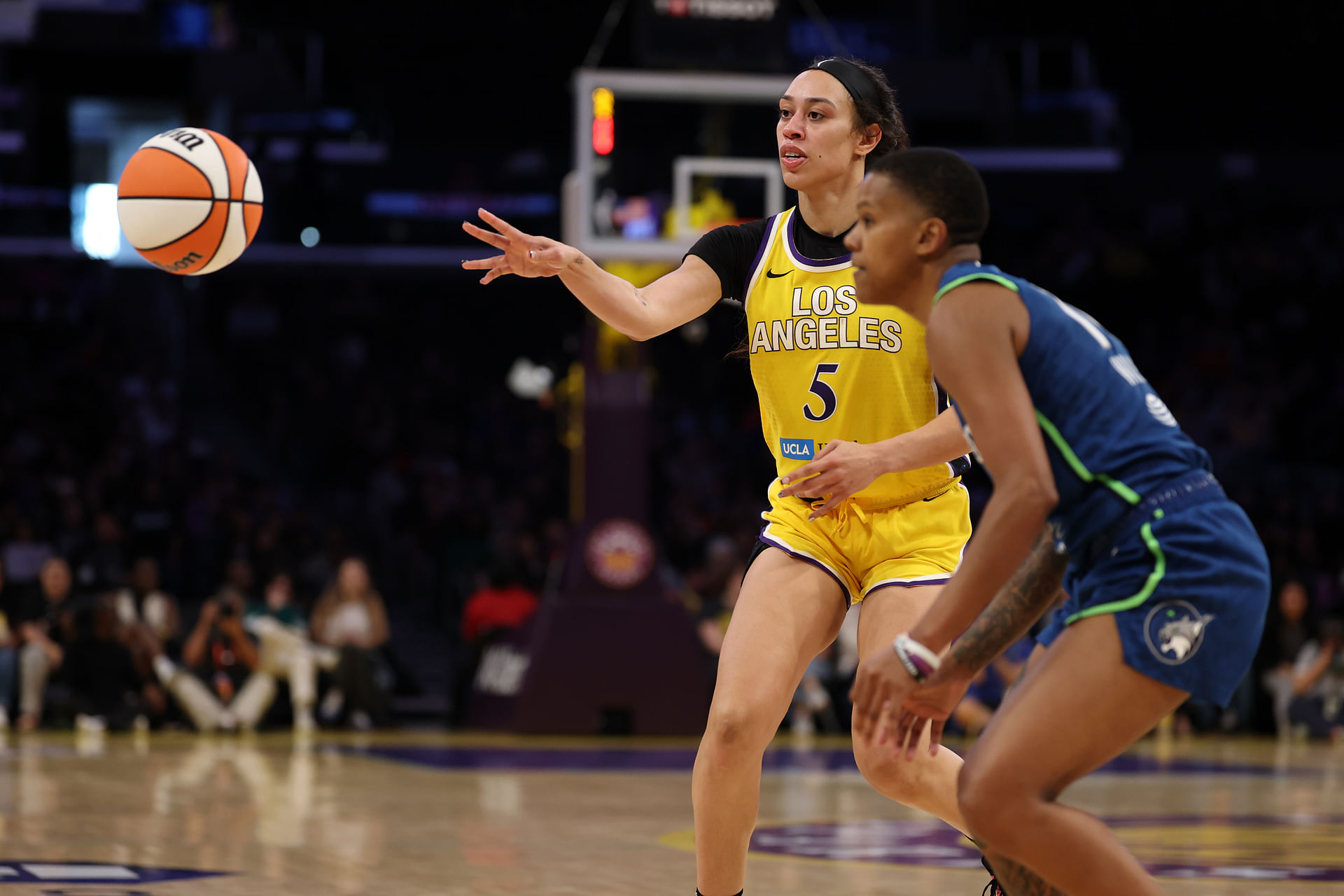 May 18, 2025; Los Angeles, California, USA; Los Angeles Sparks forward Dearica Hamby (5) passes the ball against Minnesota Lynx guard Natisha Hiedeman (2) during the second half at Crypto.com Arena. Mandatory Credit: Kiyoshi Mio-Imagn Images - Source: Imagn