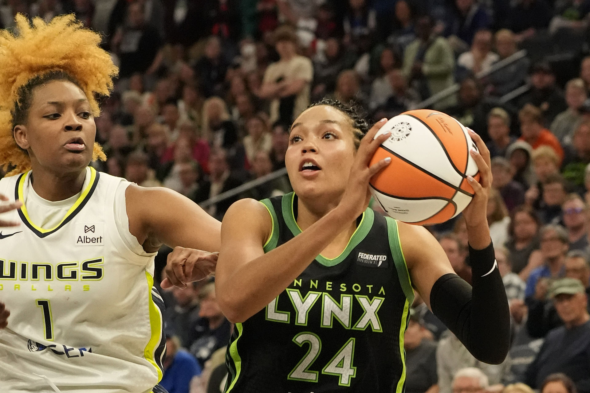 May 21, 2025; Minneapolis, Minnesota, USA; Minnesota Lynx forward Napheesa Collier (24) drives to the basket against Dallas Wings forward NaLyssa Smith (1) in the fourth quarter at Target Center. Mandatory Credit: Bruce Kluckhohn-Imagn Images - Source: Imagn