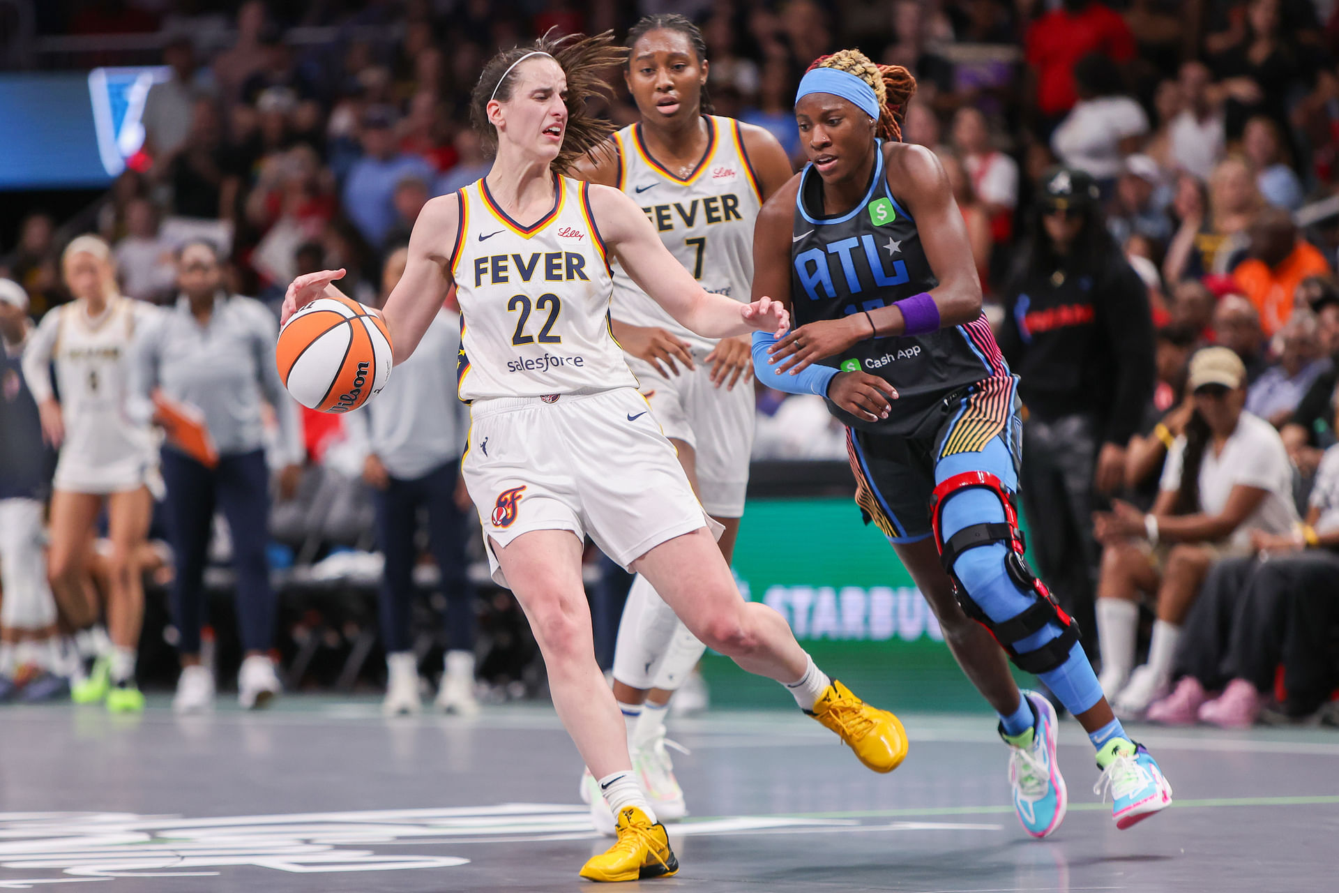 May 22, 2025; Atlanta, Georgia, USA; Indiana Fever guard Caitlin Clark (22) is fouled by Atlanta Dream guard Rhyne Howard (10) in the fourth quarter at State Farm Arena. Mandatory Credit: Brett Davis-Imagn Images - Source: Imagn