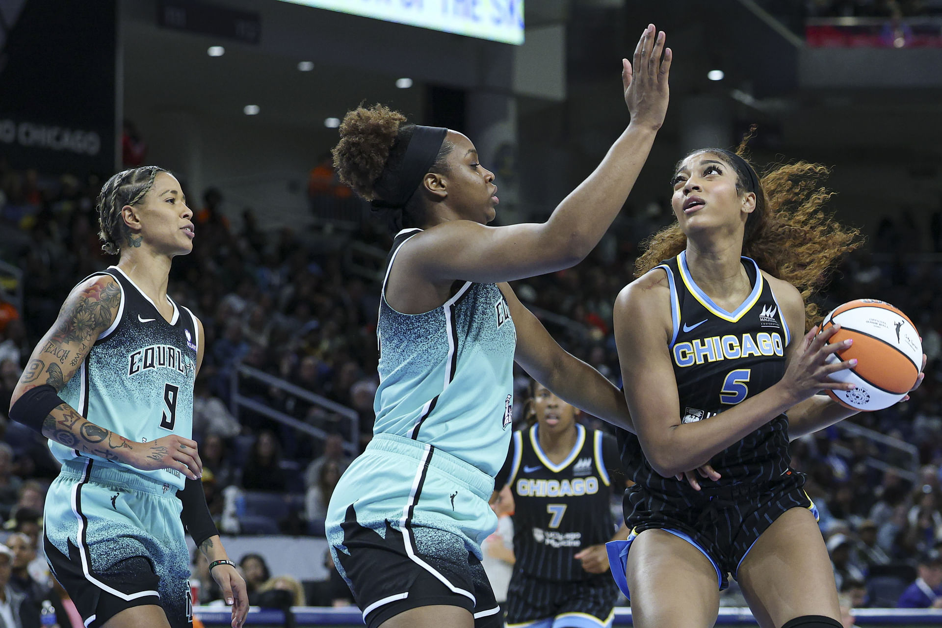 May 22, 2025; Chicago, Illinois, USA; Chicago Sky forward Angel Reese (5) drives to the basket against New York Liberty forward Kennedy Burke (22) during the second half at Wintrust Arena. Mandatory Credit: Kamil Krzaczynski-Imagn Images - Source: Imagn