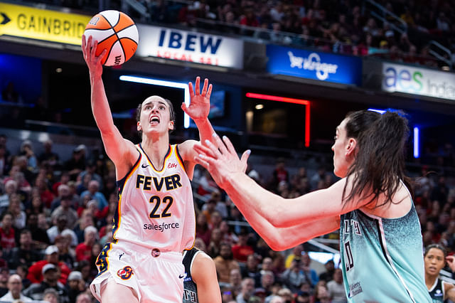 May 24, 2025; Indianapolis, Indiana, USA; Indiana Fever guard Caitlin Clark (22) shoots the ball while New York Liberty forward Breanna Stewart (30) defends in the second half at Gainbridge Fieldhouse. Mandatory Credit: Trevor Ruszkowski-Imagn Images - Source: Imagn
