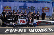 Tony Stewart celebrates with wife Leah Pruett, son Dominic Stewart, and crew after winning the Route 66 Nationals at Route 66 Raceway. - Source: Imagn