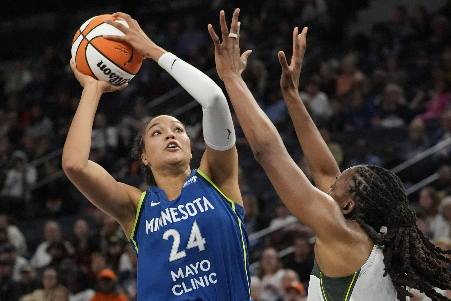 May 27, 2025; Minneapolis, Minnesota, USA; Minnesota Lynx forward Napheesa Collier (24) shoots over Seattle Storm forward Nneka Ogwumike (3) in the fourth quarter at Target Center. Mandatory Credit: Bruce Kluckhohn-Imagn Images - Source: Imagn