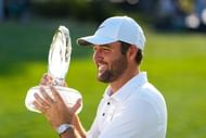 Scottie Scheffler lifts the 2025 Memorial Tournament tophy - Image Source: Imagn