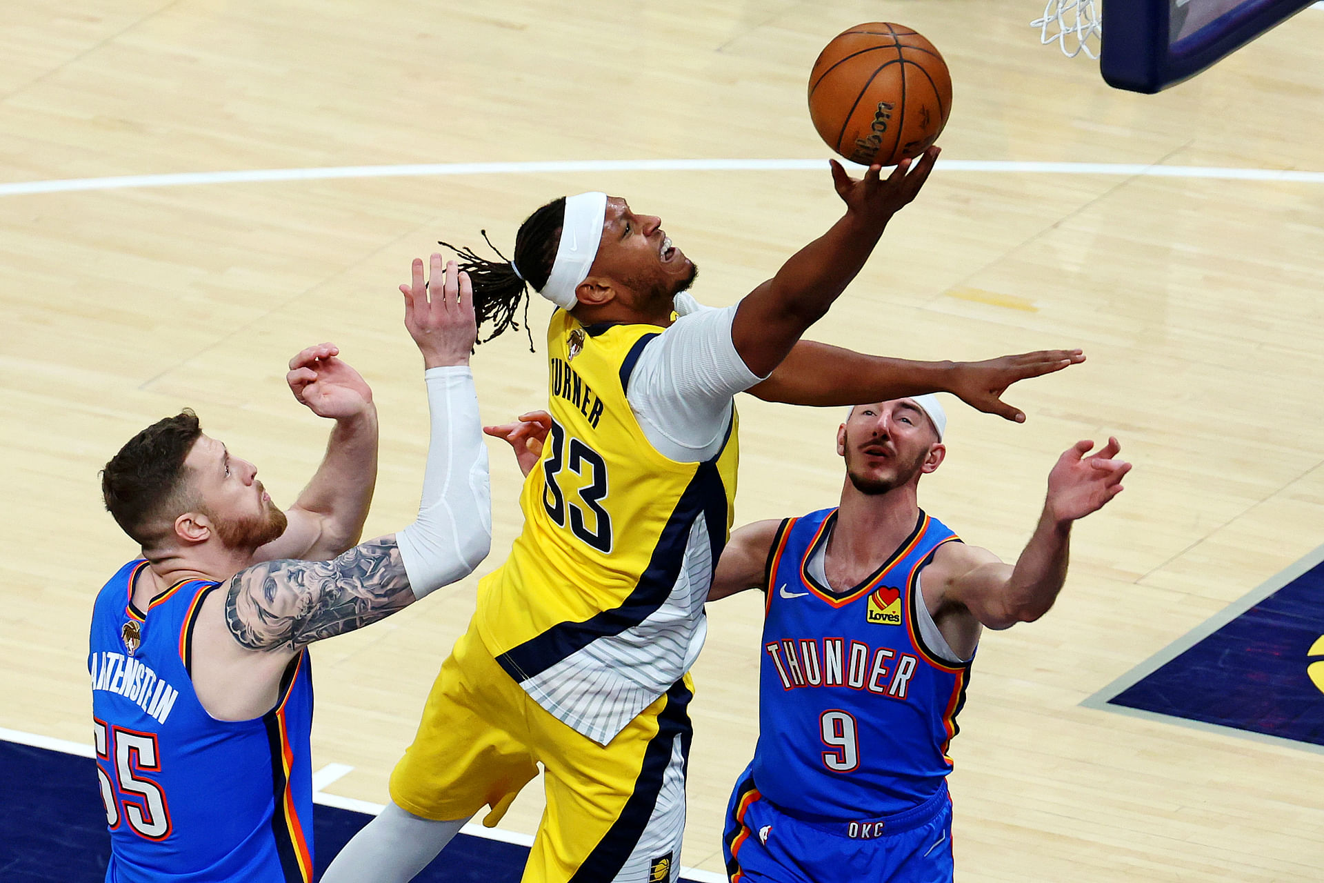 Jun 11, 2025; Indianapolis, Indiana, USA; Indiana Pacers center Myles Turner (33) shoots the ball against Oklahoma City Thunder center Isaiah Hartenstein (55) and guard Alex Caruso (9) during the first quarter in game three of the 2025 NBA Finals at Gainbridge Fieldhouse. Mandatory Credit: Trevor Ruszkowski-Imagn Images - Source: Imagn