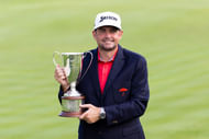 Keegan Bradley lifts the 2025 Travelers Championship Trophy - Image Source: Imagn
