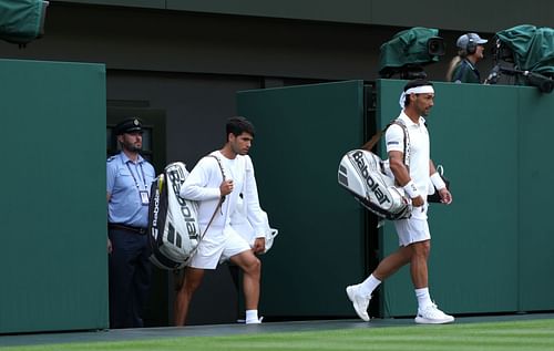Carlos Alcaraz and Fabio Fognini walk onto Centre Court | Image Source: Getty