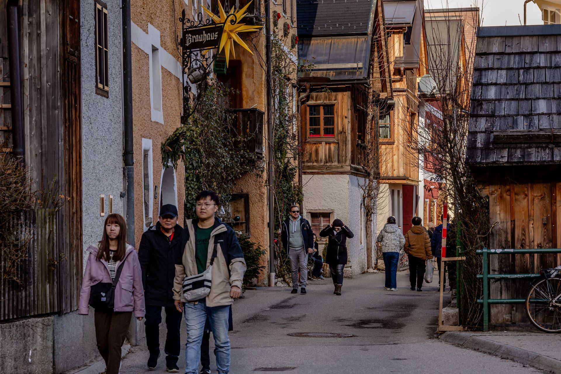 Travel Destination: Hallstatt, Austria Tourists walk in the Hallstatt village on February 7, 2024. (Photo by Manuel Romano/NurPhoto via Getty Images)