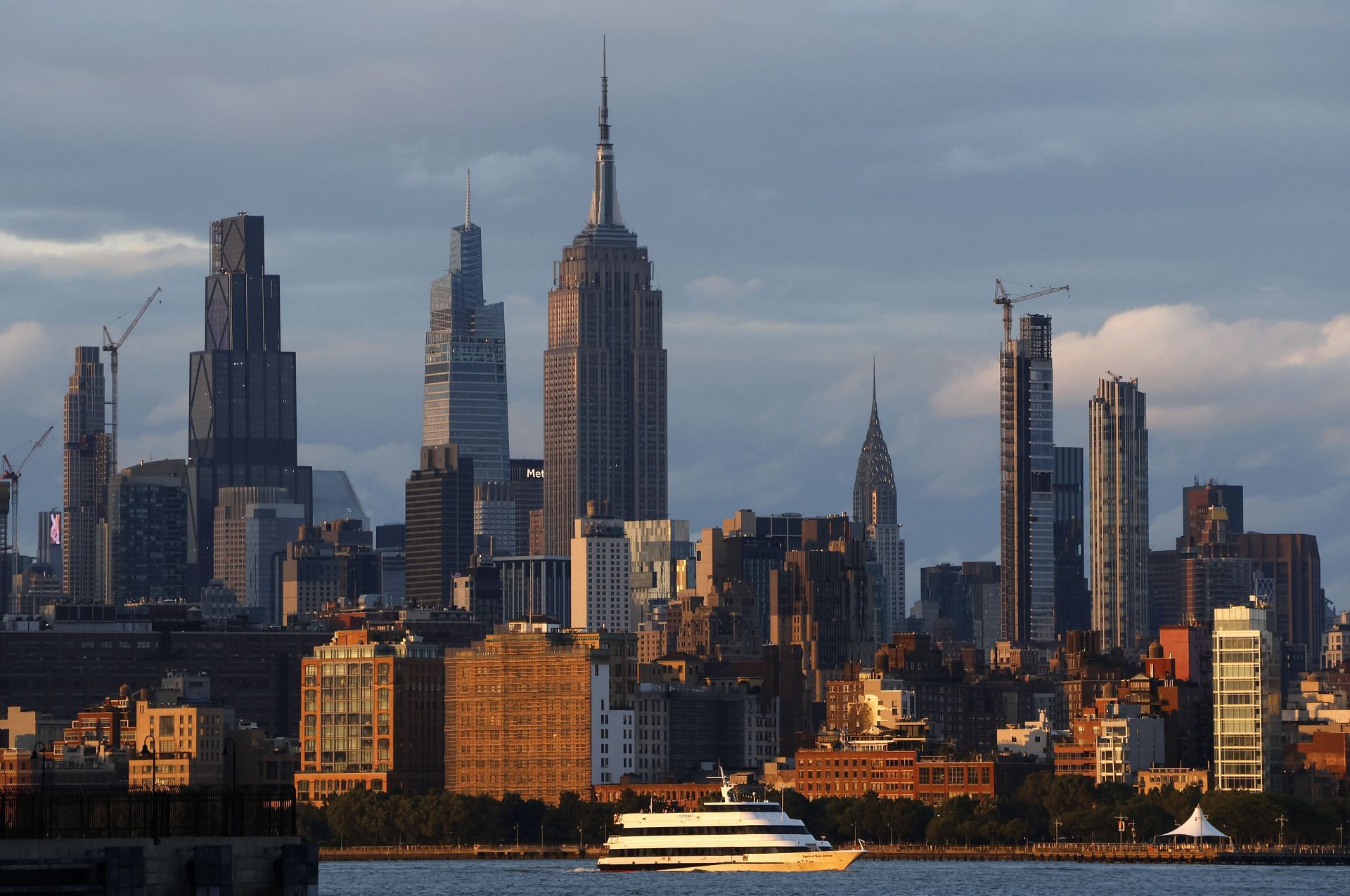 The sun sets on the skyline of midtown Manhattan and the Empire State Building in New York City on May 31, 2025, as seen from Jersey City, New Jersey. (Photo by Gary Hershorn/Getty Images)