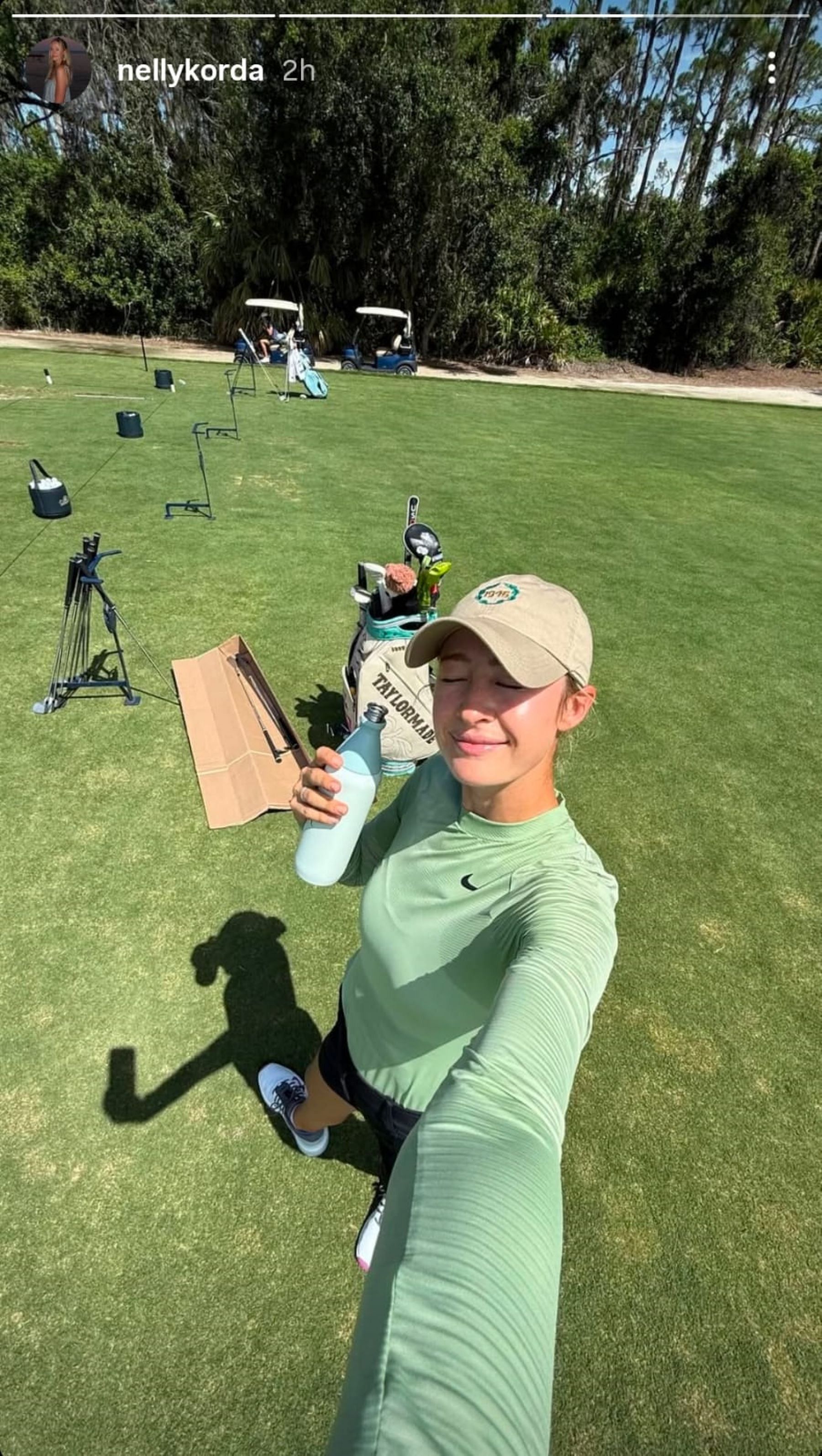 Nelly Korda shares a selfie from her practice range session, holding her green Stanley water bottle (via IG/@nellykorda)