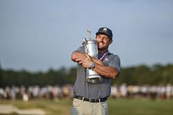 Bryson DeChambeau kisses the US Open trophy "one last time" as he arrives at Oakmont