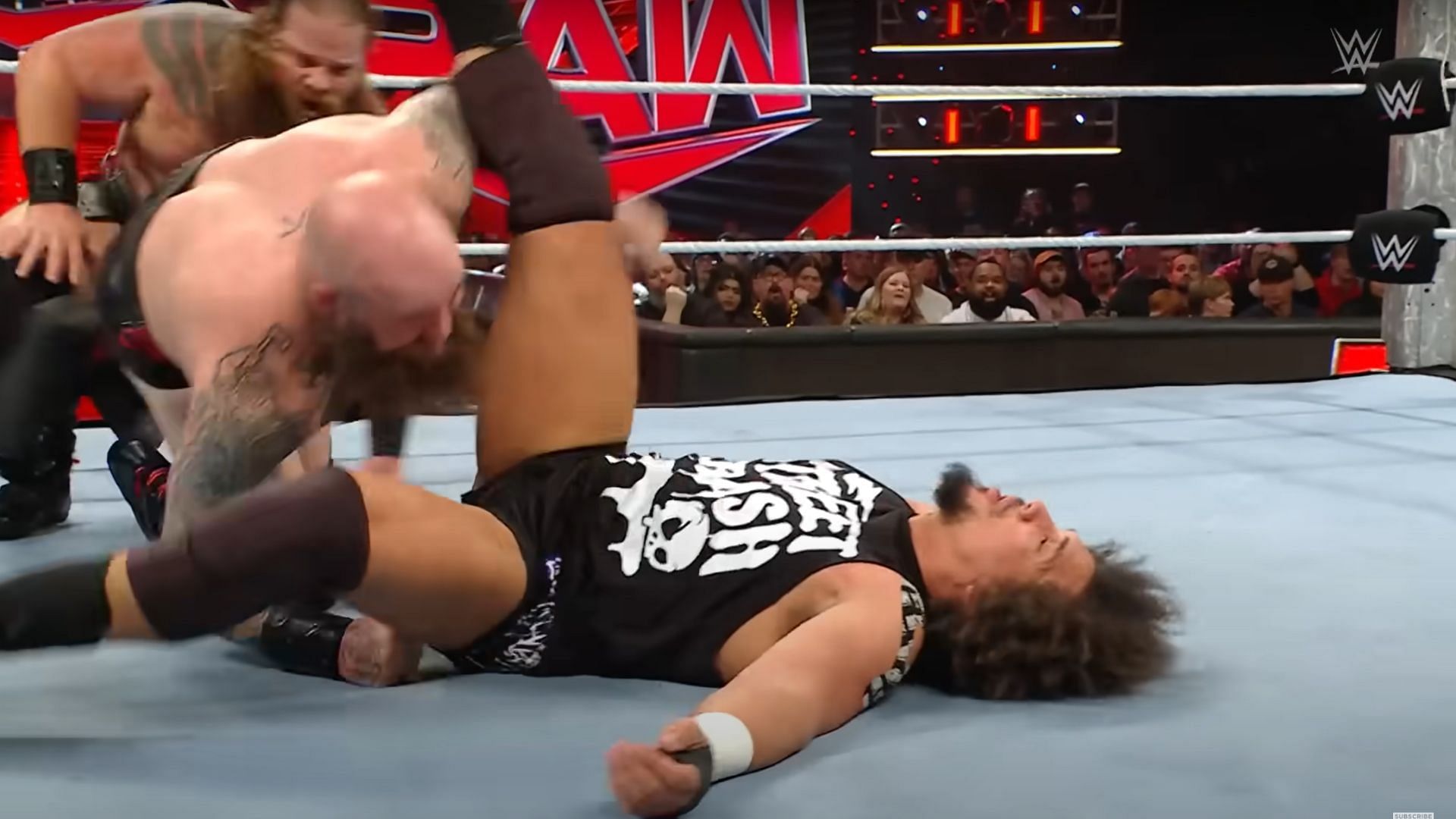 The War Raiders towering over Carlito [Image Credits: WWE