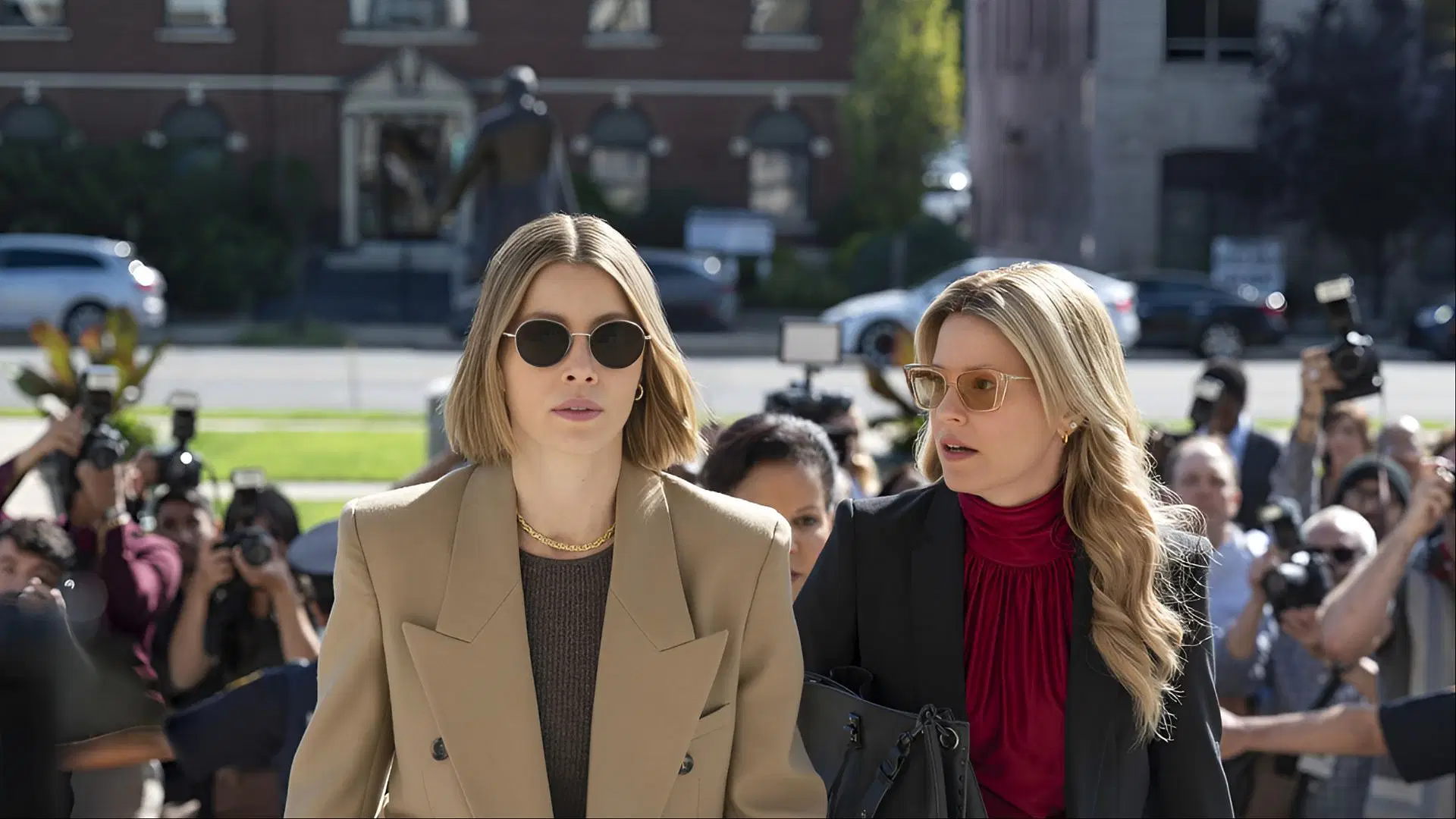 Jessica Biel and Elizabeth Banks as Chloe and Nicky walk past reporters during a high-stakes legal showdown in The Better Sister. (Image via Amazon Prime)