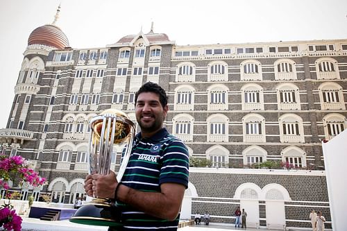 Yuvraj Singh poses with the 2011 ICC World Cup trophy. [Source: Getty]