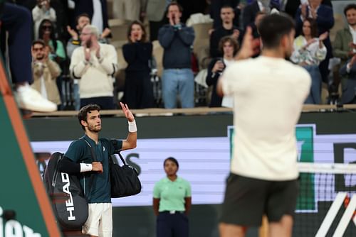 Carlos Alcaraz shows respect as Lorenzo Musetti retires at the 2025 French Open - Image Source: Getty
