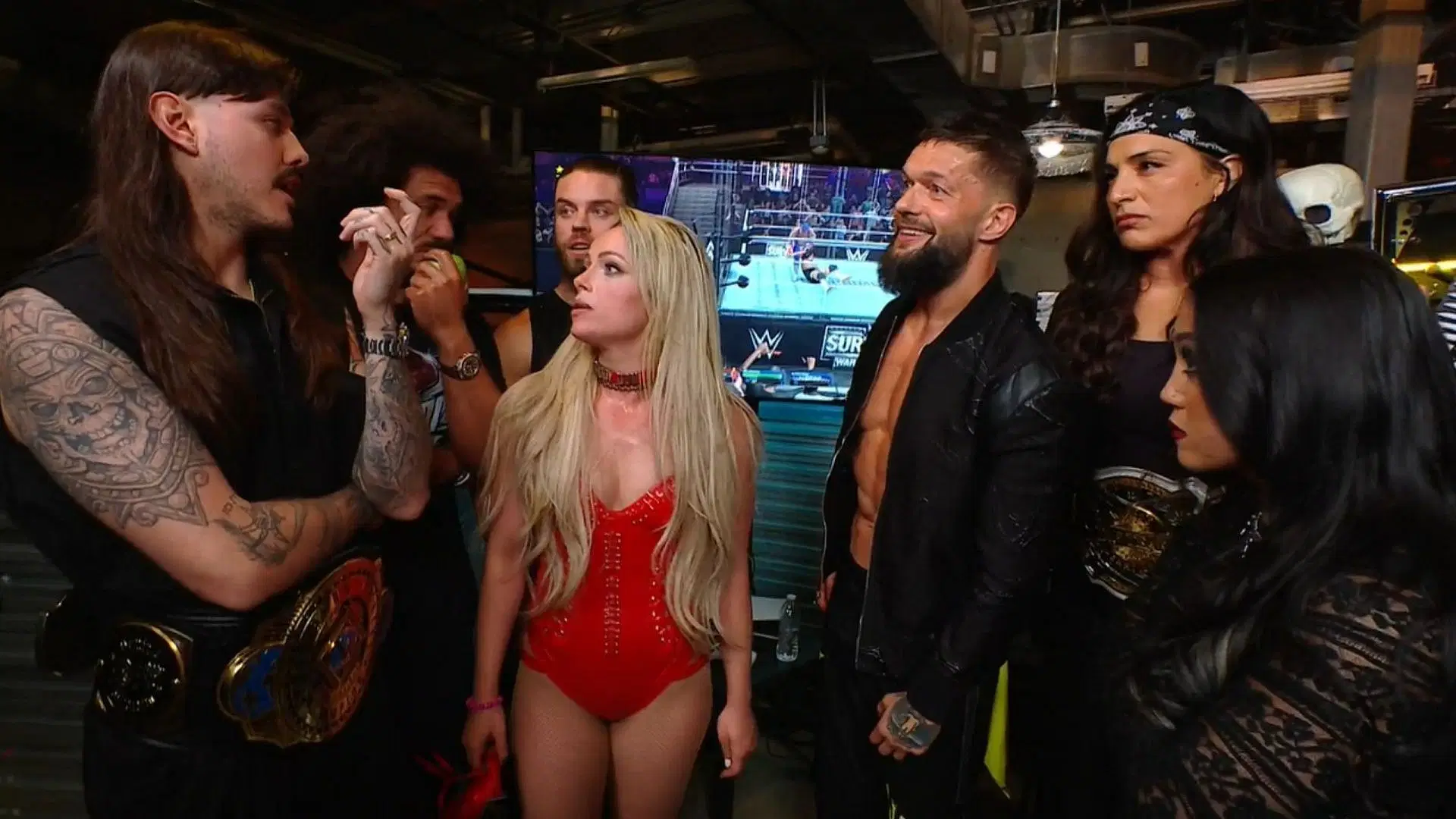 Liv Morgan with The Judgment Day members [Image Credits: wwe.com]