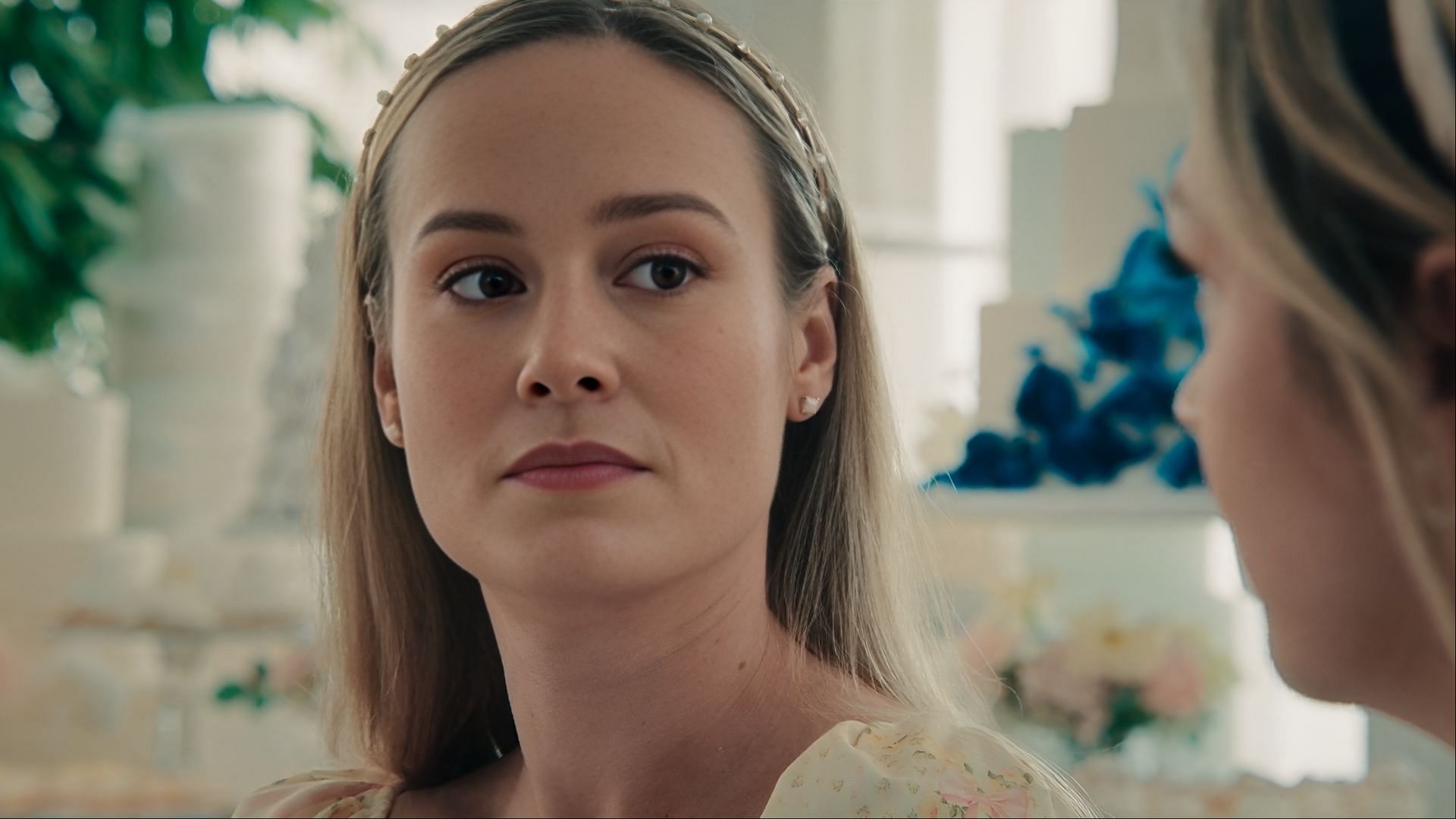 Brie Larson as Francie Fak looking at Natalie with a serious expression during a wedding scene in The Bear season 4.