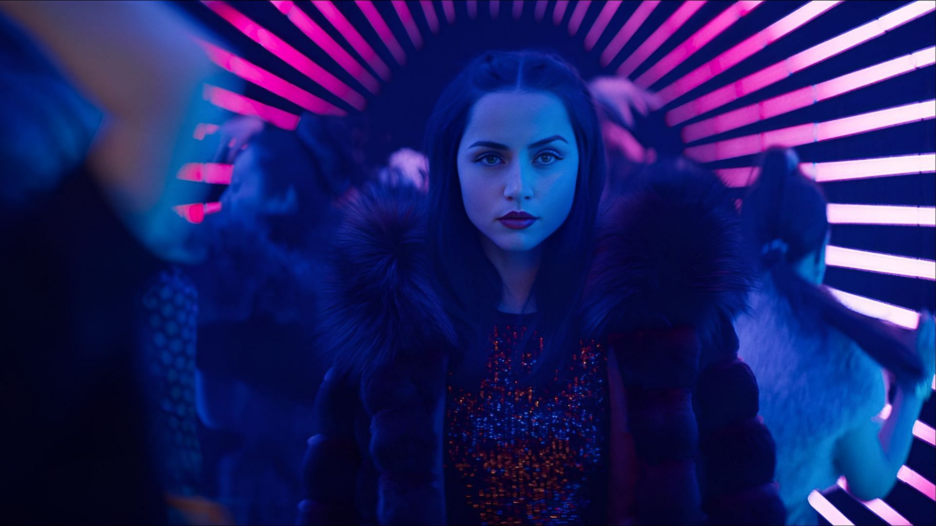 Ana de Armas as Eve Macarro in a fur coat walking through a neon-lit club tunnel in Ballerina (2025).