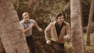 Chris Robinson (right) running through a wooded area in an action sequence from an early film role. (Image via Garagehouse Pictures)
