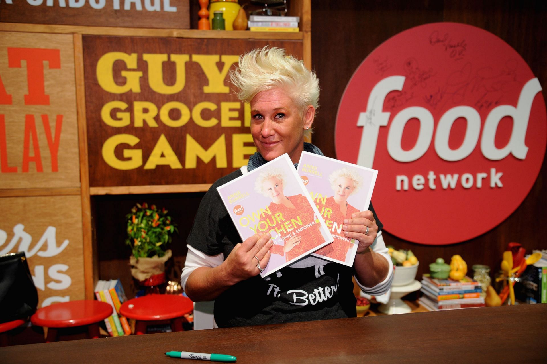 Chef Anne Burrell poses with her book &quot;Own Your Own Kitchen&quot; during the Food Network New York City Wine &amp; Food Festival on October 19, 2014, in New York City. (Photo by Bryan Bedder/Getty Images for NYCWFF)