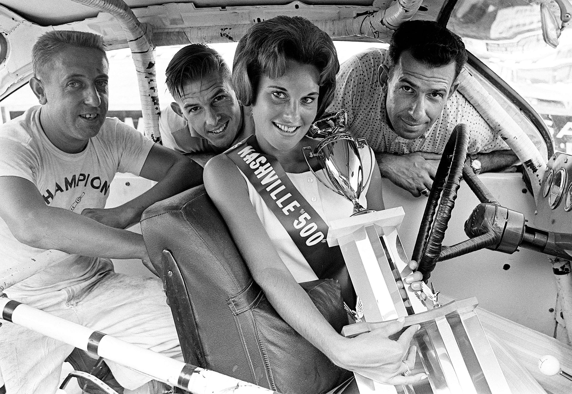 Miss Nashville 500 - Carol Steele (C) flanked by Rex White (L-R), Johnny Allen, and Ned Jarrett on Aug. 5, 1961. Source: Imagn