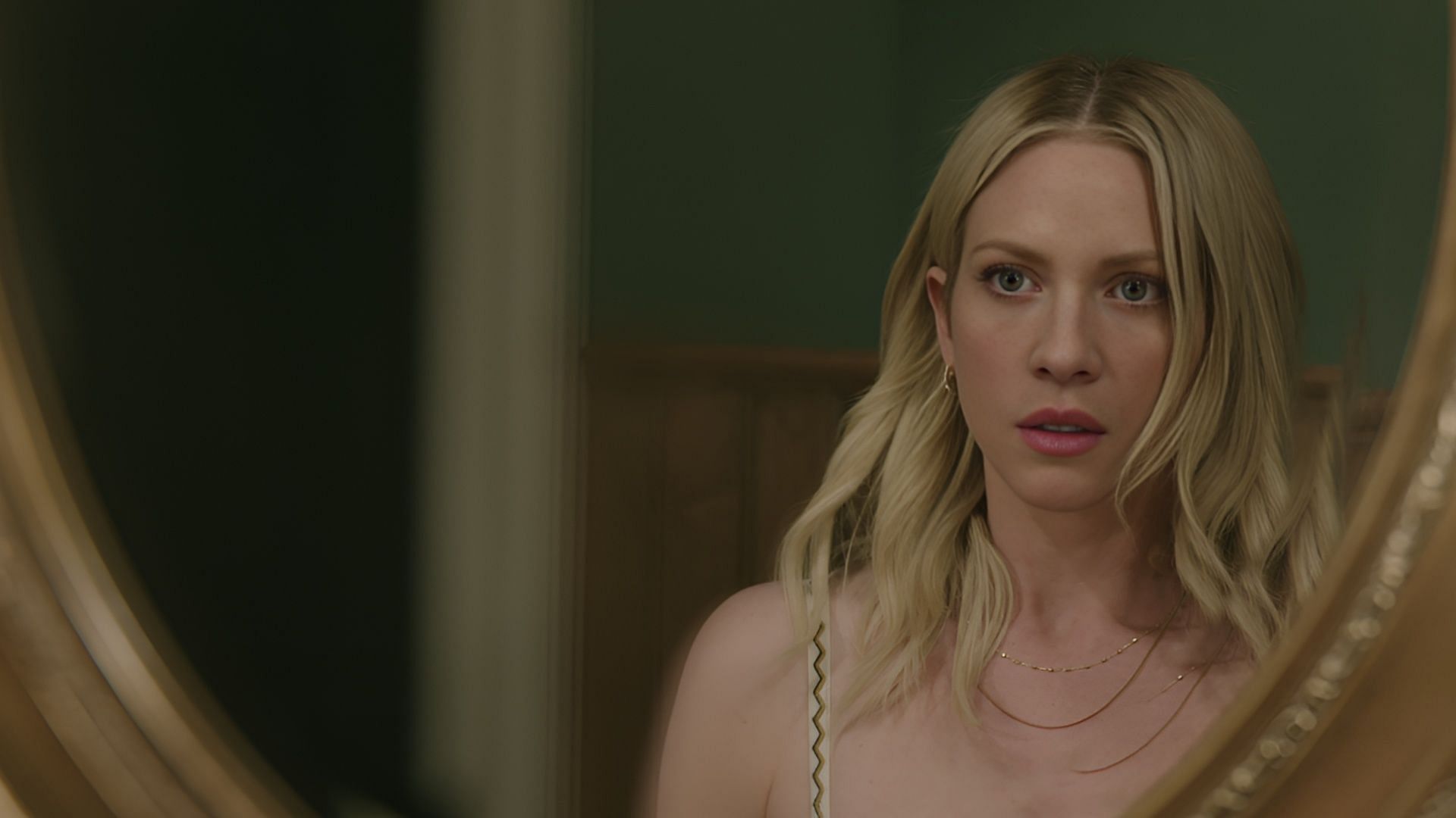 Brittany Snow as Sophie O&rsquo;Neill staring into a mirror with a tense expression in The Hunting Wives season 1.