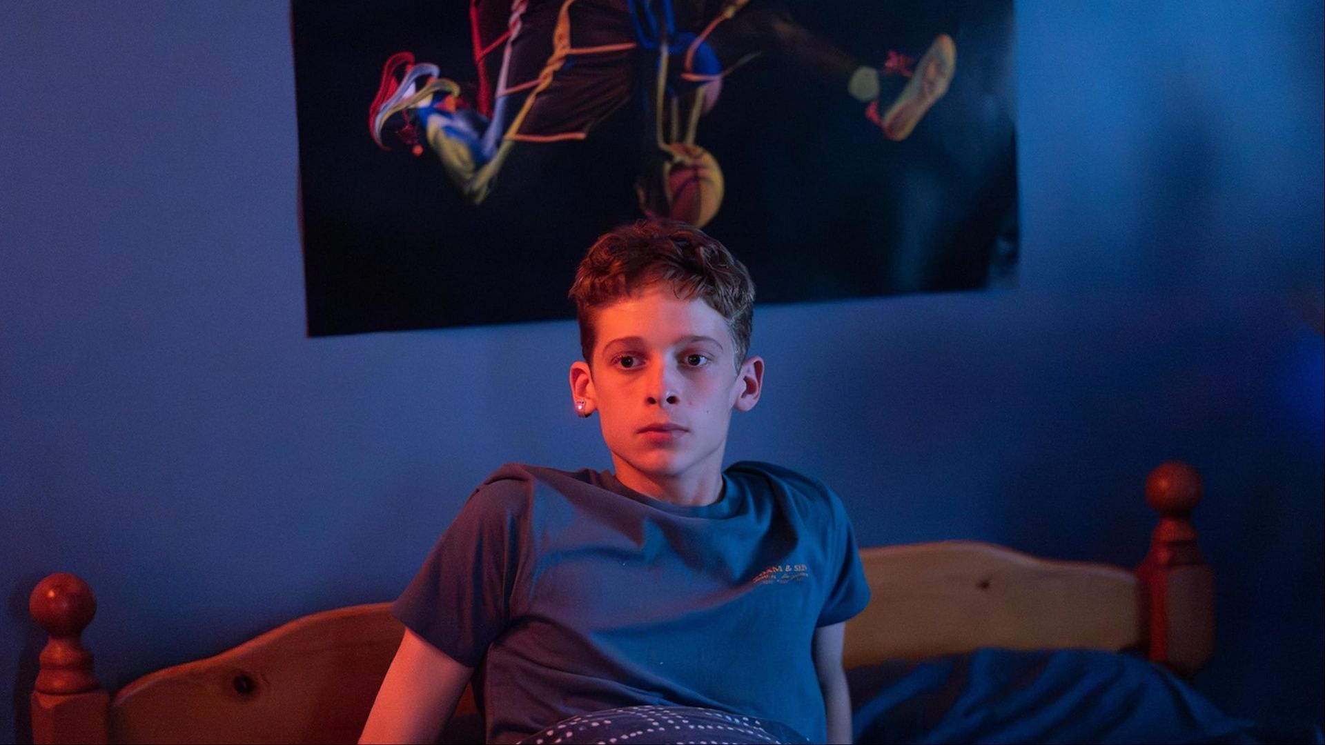 Luke Ellis sitting in a staged replica of his bedroom at the Institute in season 1.