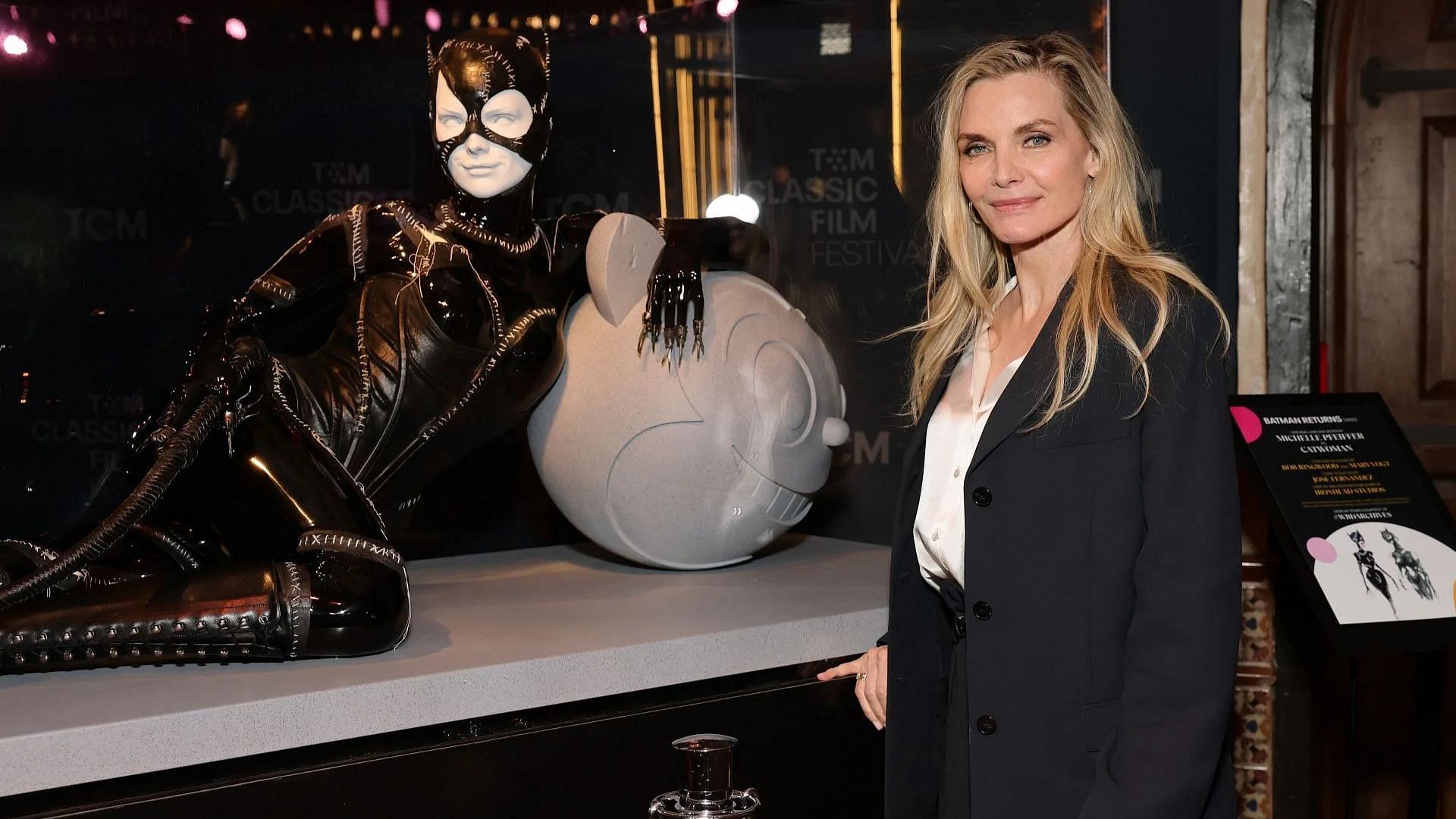 Michelle Pfeiffer poses with the catsuit from &quot;Batman Returns&quot; (Image via Getty)