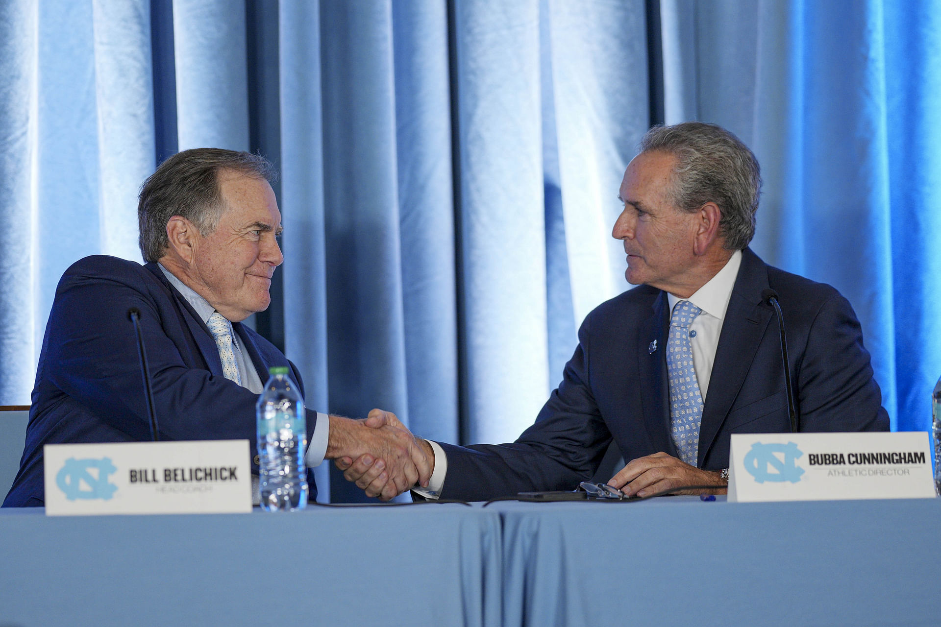 North Carolina Tar Heels&#039; new head coach Bill Belichick (L) shakes hands with athletic director Bubba Cunningham. Source: Imagn