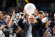 UConn Huskies head coach Geno Auriemma holds up the WBCA Coaches’ trophy. Photo: Imagn