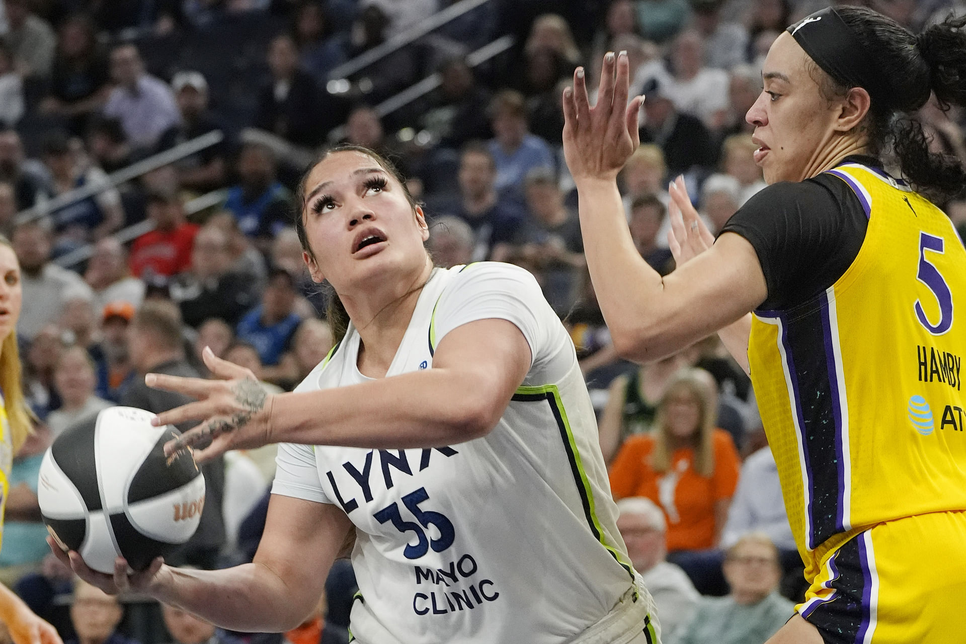 Jun 14, 2025; Minneapolis, Minnesota, USA; Minnesota Lynx forward Alissa Pili (35) goes to the basket against Los Angeles Sparks forward Dearica Hamby (5) in the fourth quarter at Target Center. Mandatory Credit: Bruce Kluckhohn-Imagn Images - Source: Imagn
