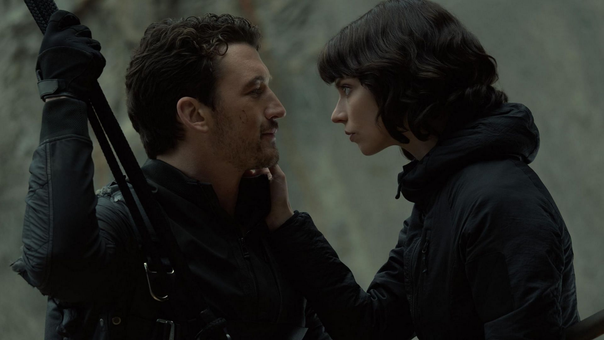 Miles Teller and Anya Taylor-Joy facing each other closely in an intense scene.