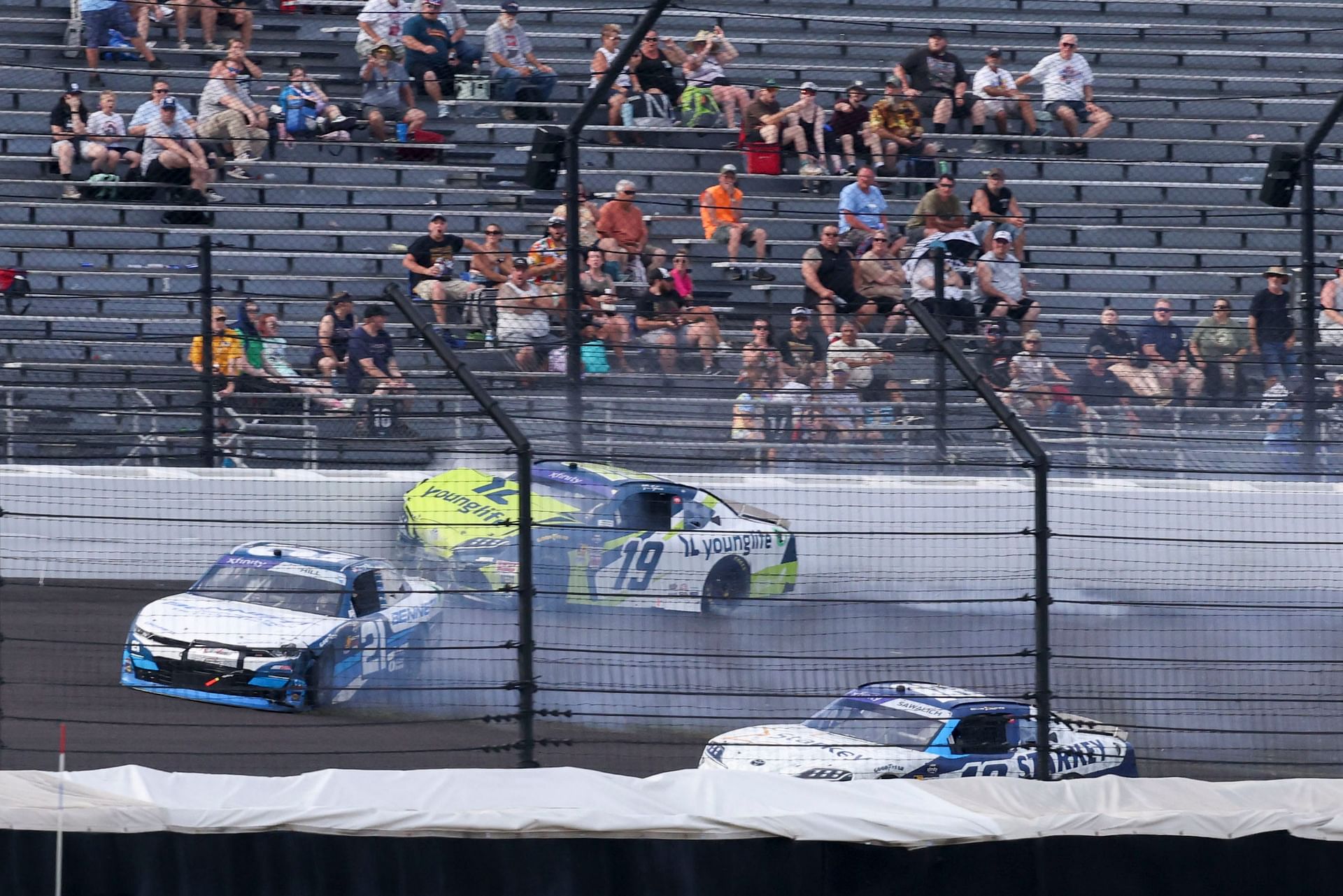 Austin Hill (21) and Aric Almirola (19) collide during the Pennzoil 250. Source: Imagn
