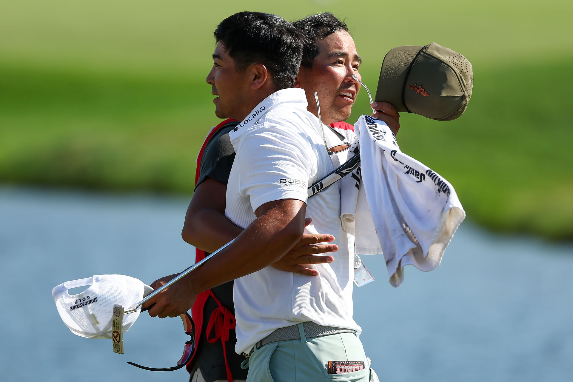 ; Kurt Kitayama celebrates with caddie Daniel Kitayama after winning the 3M Open (Image Source: Imagn)