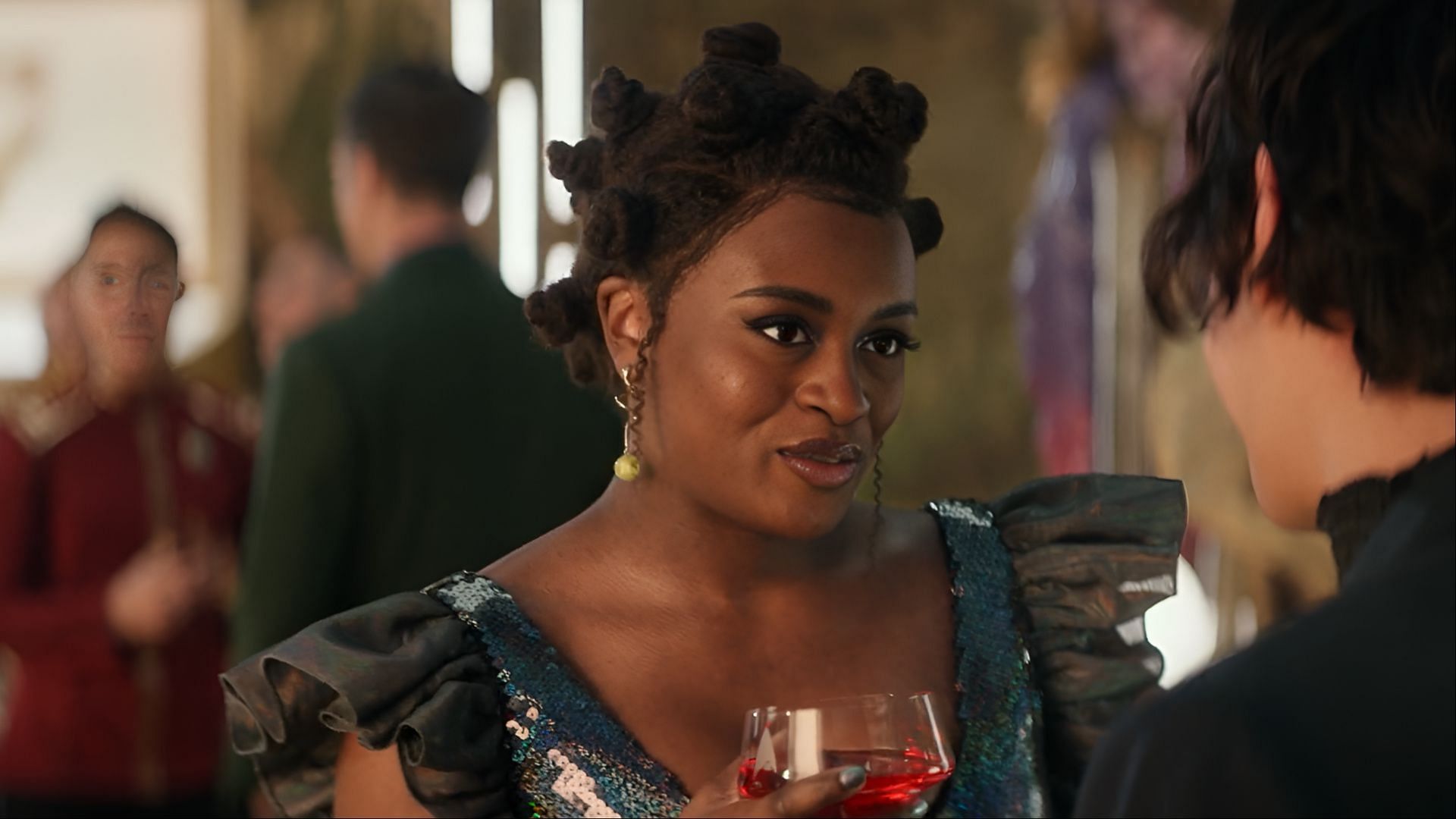 Uhura shares a flirtatious moment with Beto at the Federation gala in Star Trek: Strange New Worlds season 3, hinting at a new romantic subplot. (Image via Paramount+)