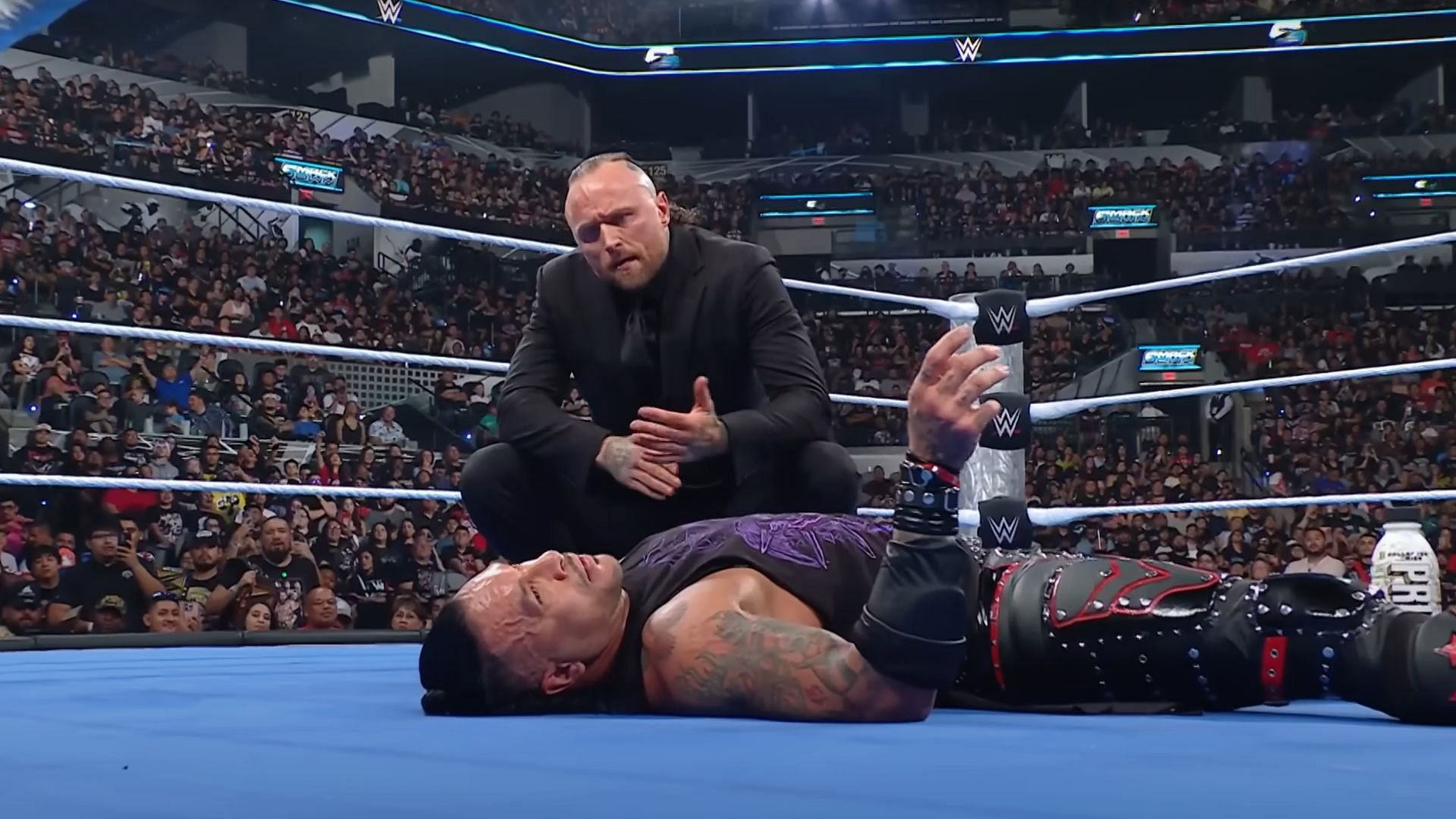 Aleister Black looks down on Damian Priest after knocking him down [Image Credits: WWE