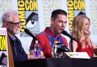 (Left to right) James Gunn, John Cena, and Jennifer Holland at 2025 Comic-Con International: San Diego - HBO Max "Peacemaker" Sneak Peek And Panel (Image via Getty)
