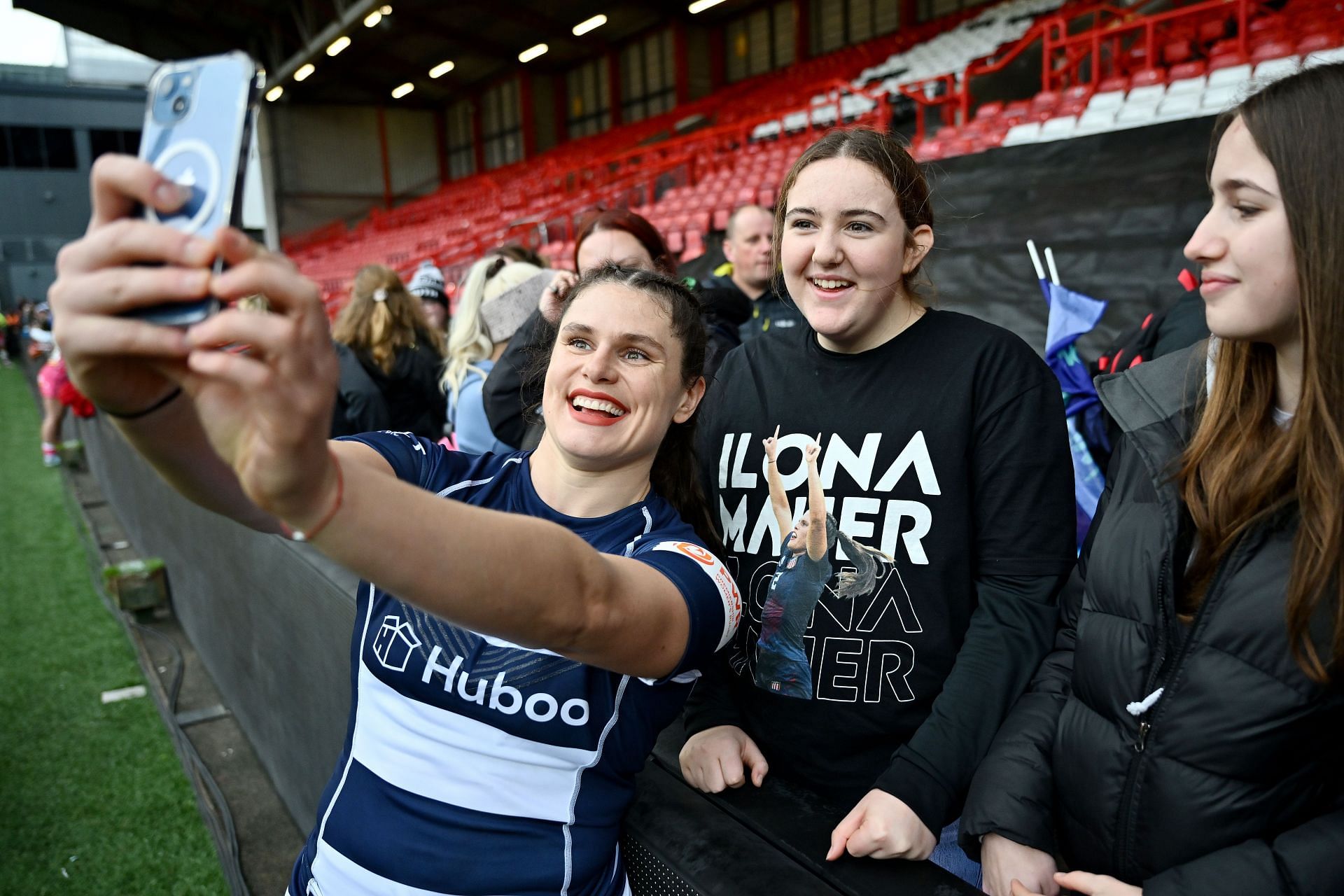 Ilona Maher poses for a photograph with fans at the Allianz Premiership Women's Rugby match (Photo by Dan Mullan/Getty Images)