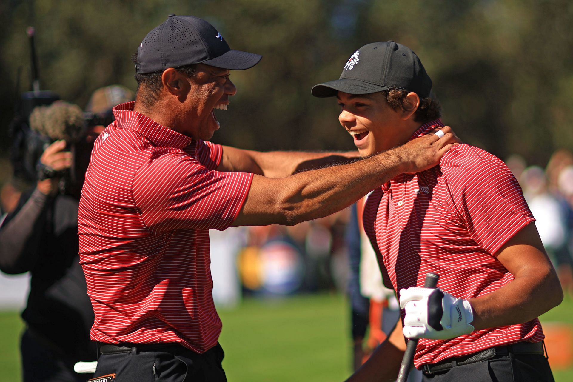 Tiger Woods & Charlie Woods share a laugh after the latters impressive putt at Pinehurst CC