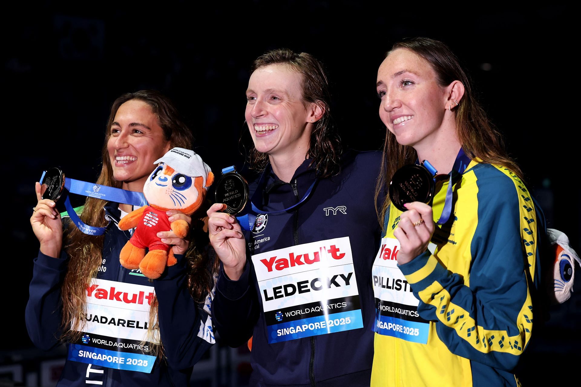 Simona Quadarella, Katie Ledecky, and Lani Pallister at the 2025 World Aquatics Championships in Singapore. (Photo by Getty Images)