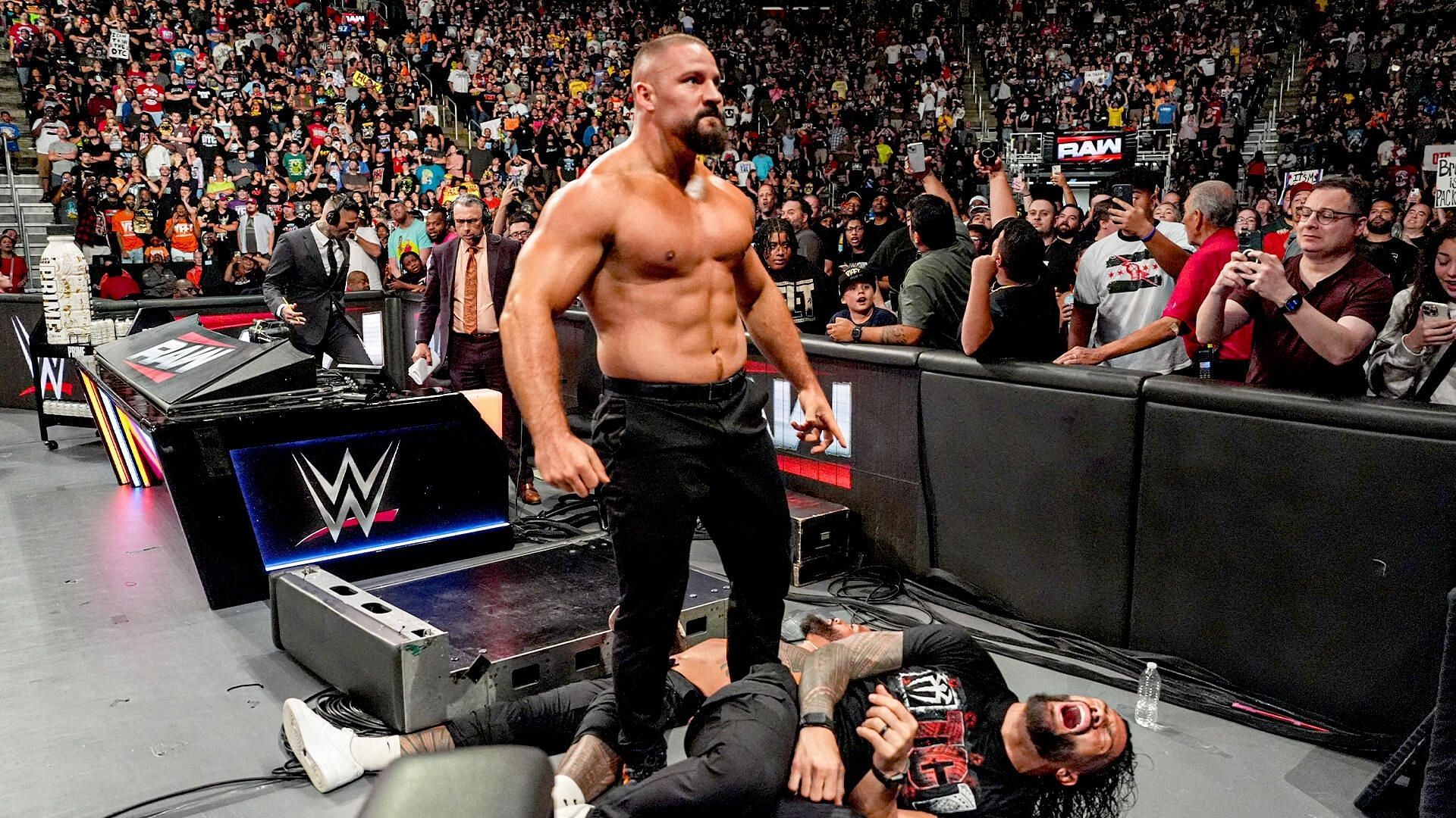 Bron Breakker towering over Roman Reigns [Image Credits: WWE.com]