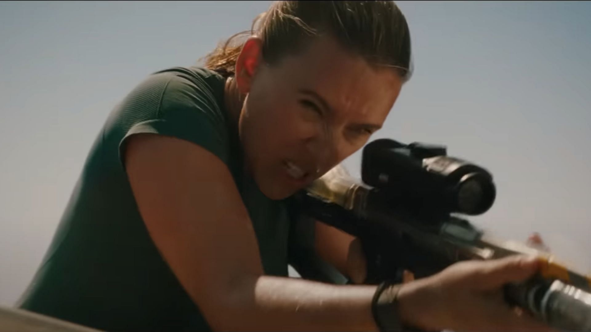 Johansson shoots at a sea-borne predator (Image via YouTube/ Universal Pictures)