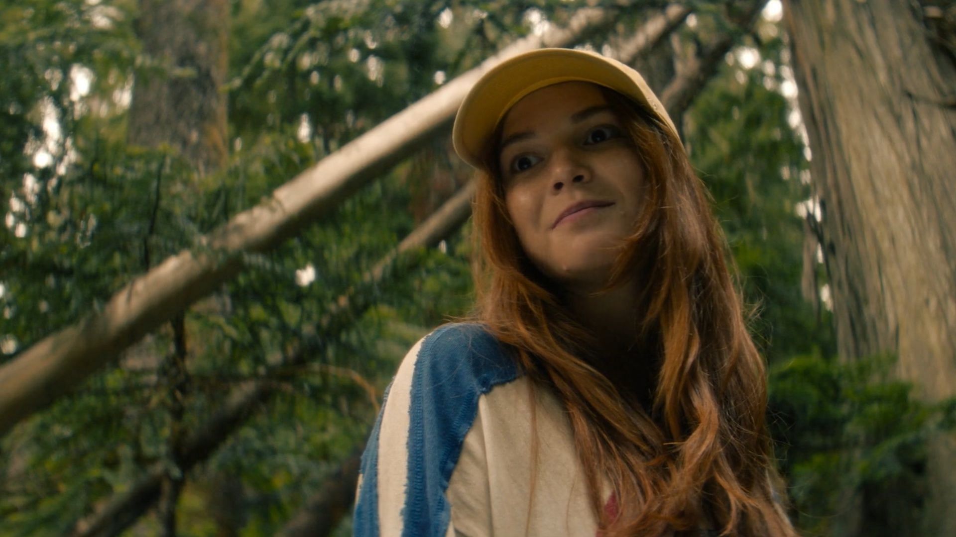 A rare light moment with Lucy wearing her signature yellow cap in Untamed (Image via Netflix)