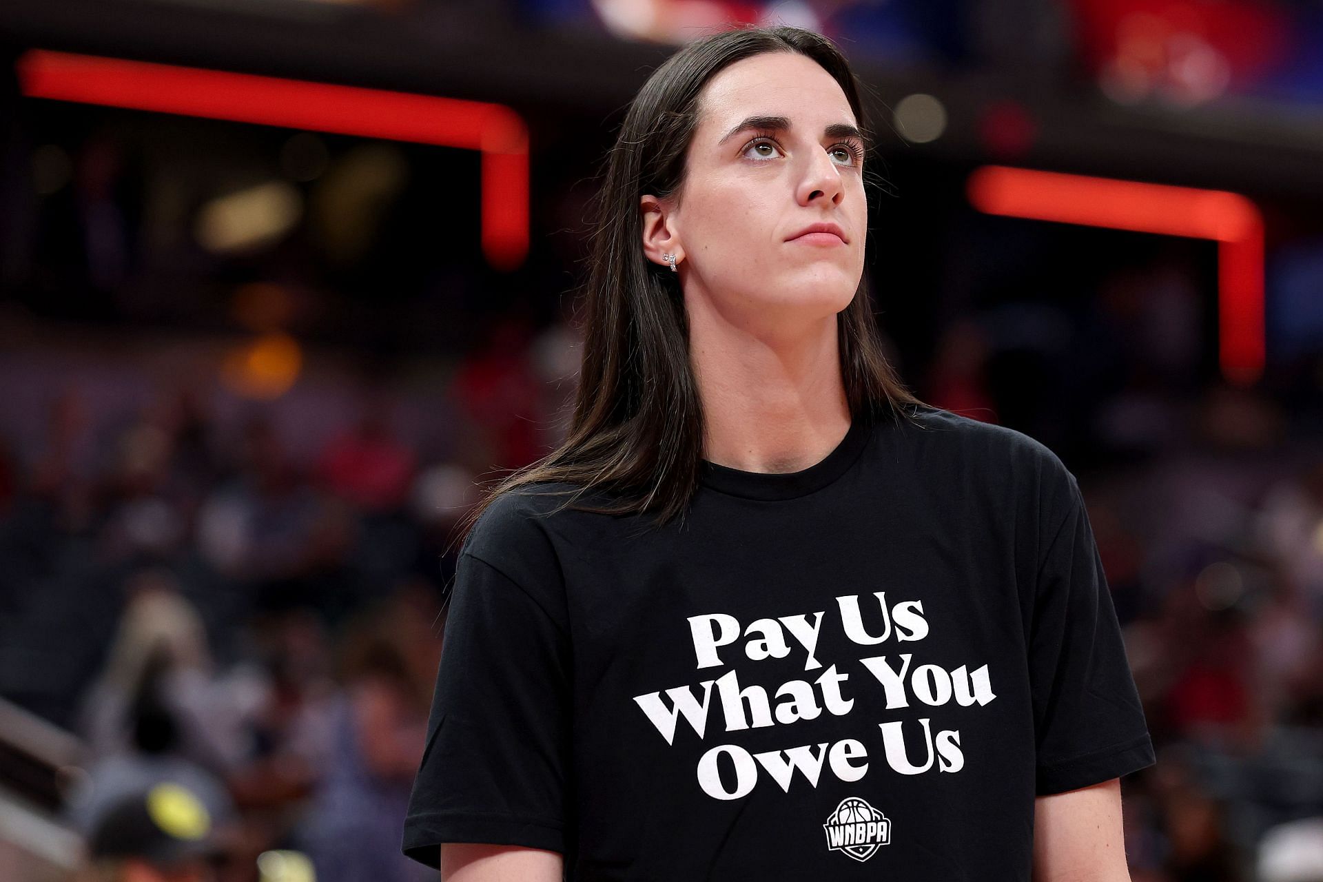 Caitlin Clark #22 of the Indiana Fever wears a shirt saying &quot;Pay us what you owe us&quot; before the 2025 AT&amp;T WNBA All-Star Game - Source: Getty